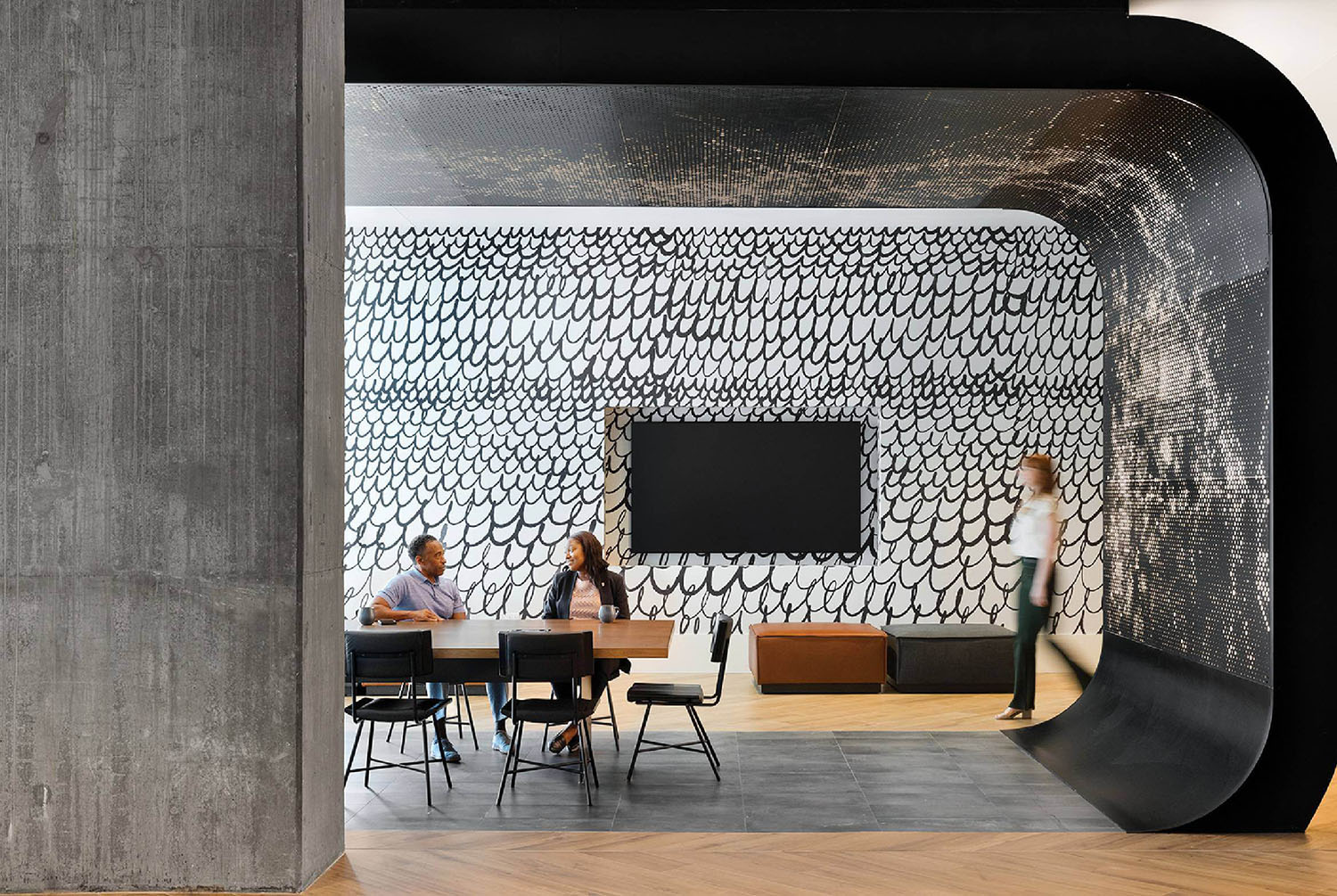 A room with a large black and white wall.