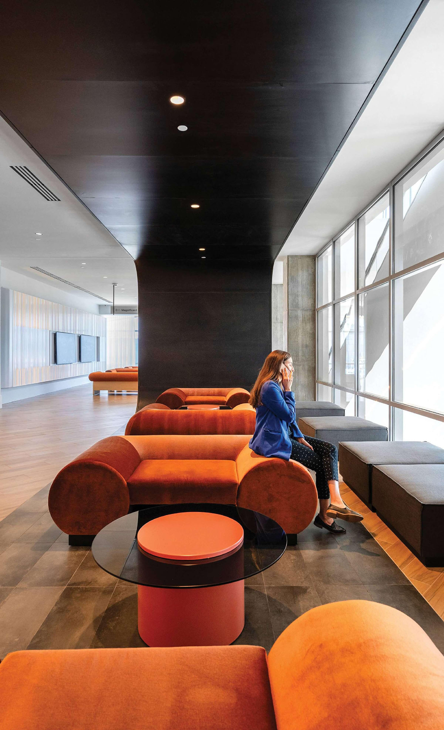 A woman sitting on a couch in a room.