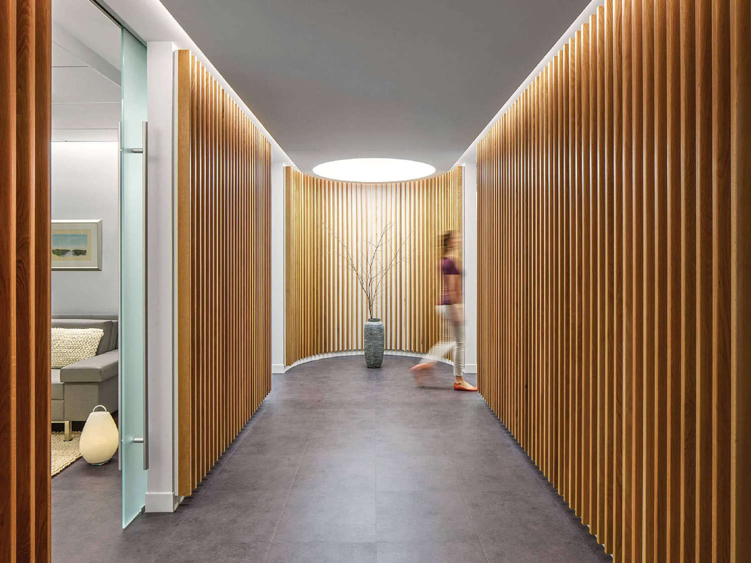 A hallway with wooden sls and a white wall