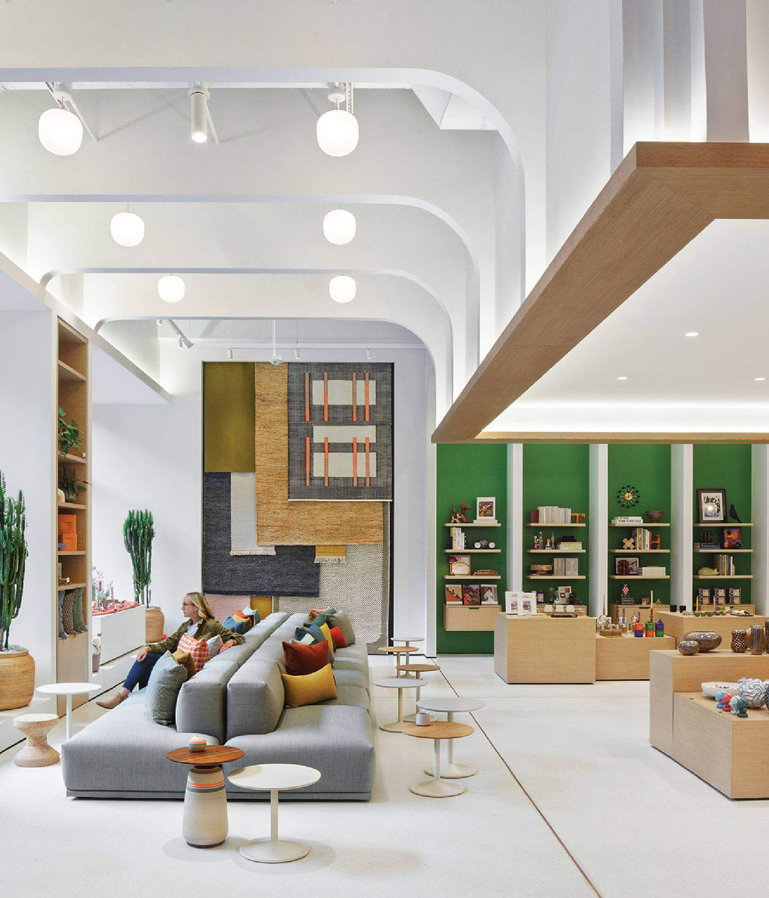 A large room with a couch, chairs and a fireplace.