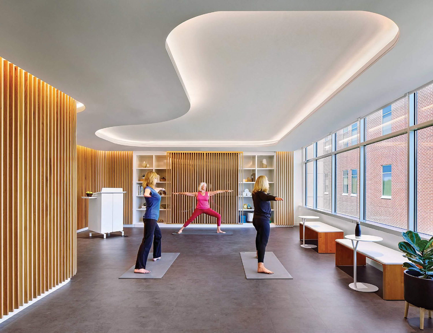 A yoga room with a woman doing yoga