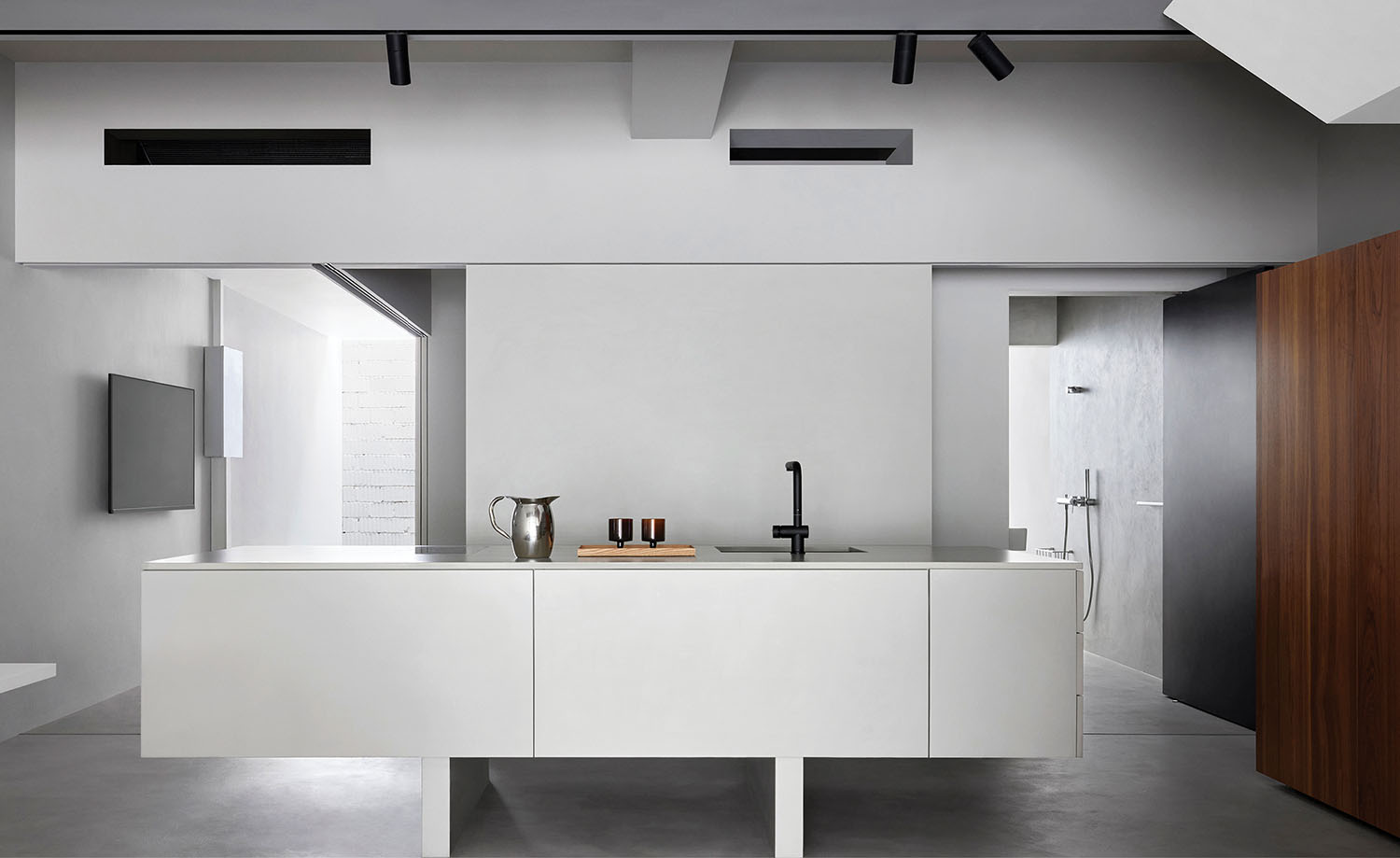 A white kitchen with a wooden cabinet and a wooden cabinet