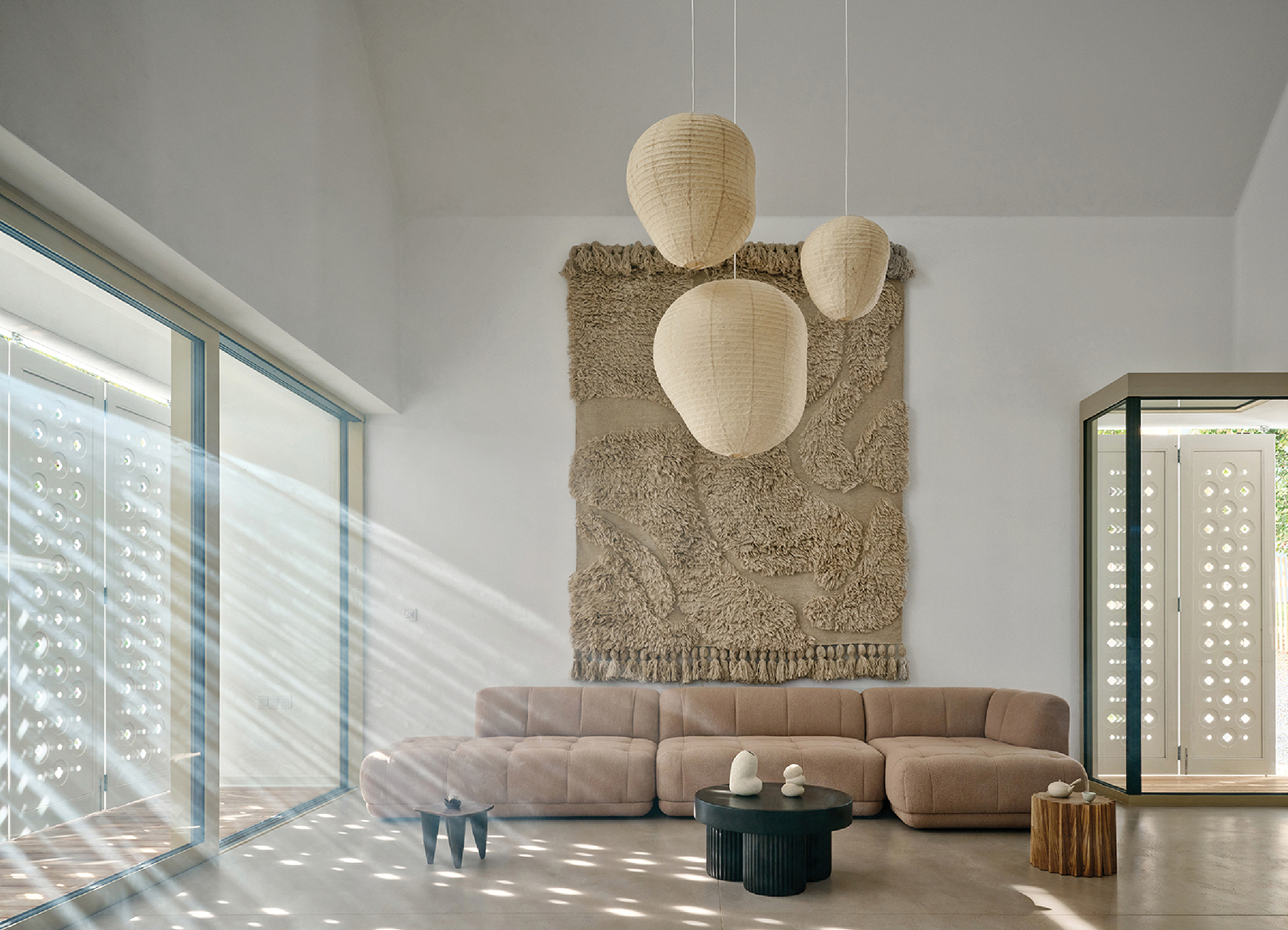 Japandi interior design living room with a large wall hanging over the couch.