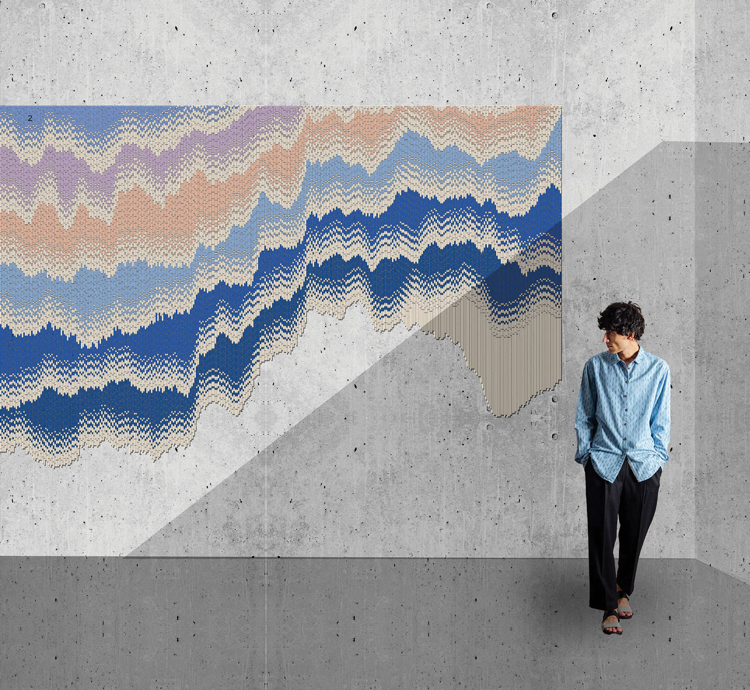 A man standing in front of a wall with a painting on it.