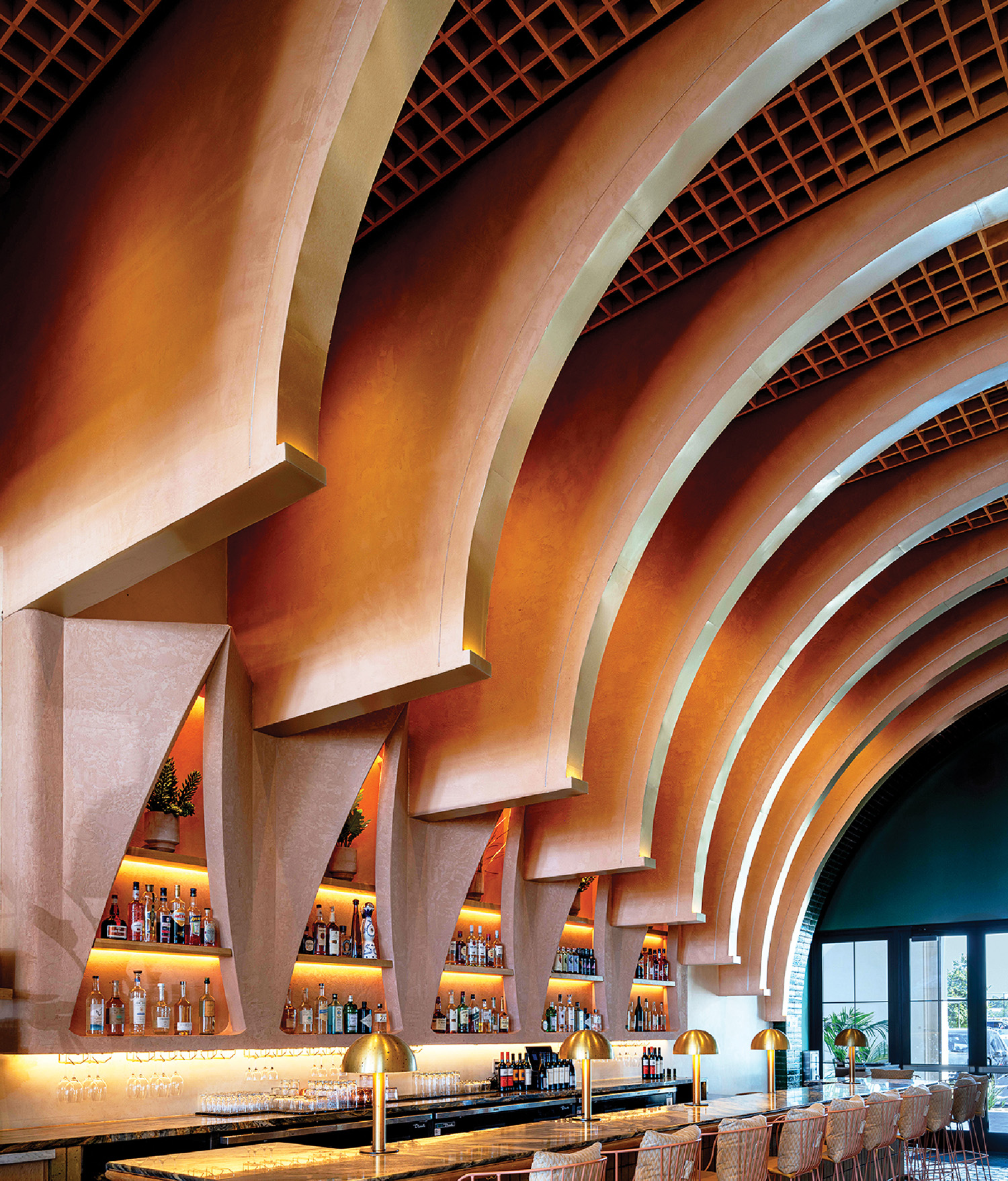 A bar with a long counter and a long bar stool.