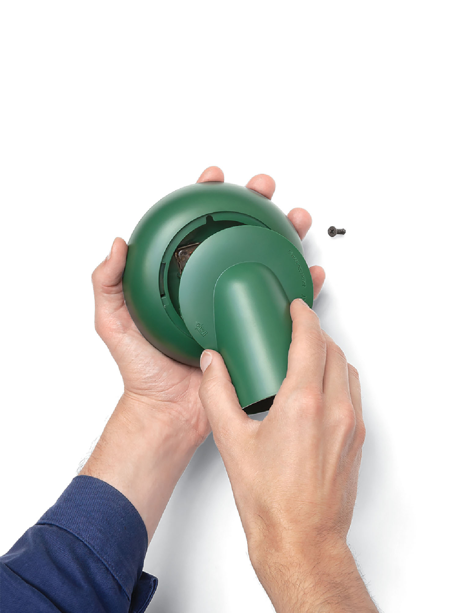 A person holding a green object in their hand.