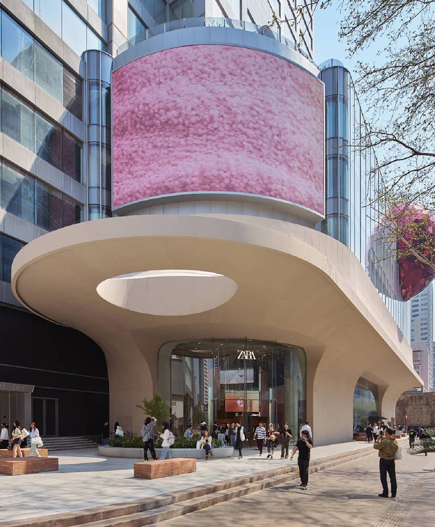A large building with a pink canopy on the side