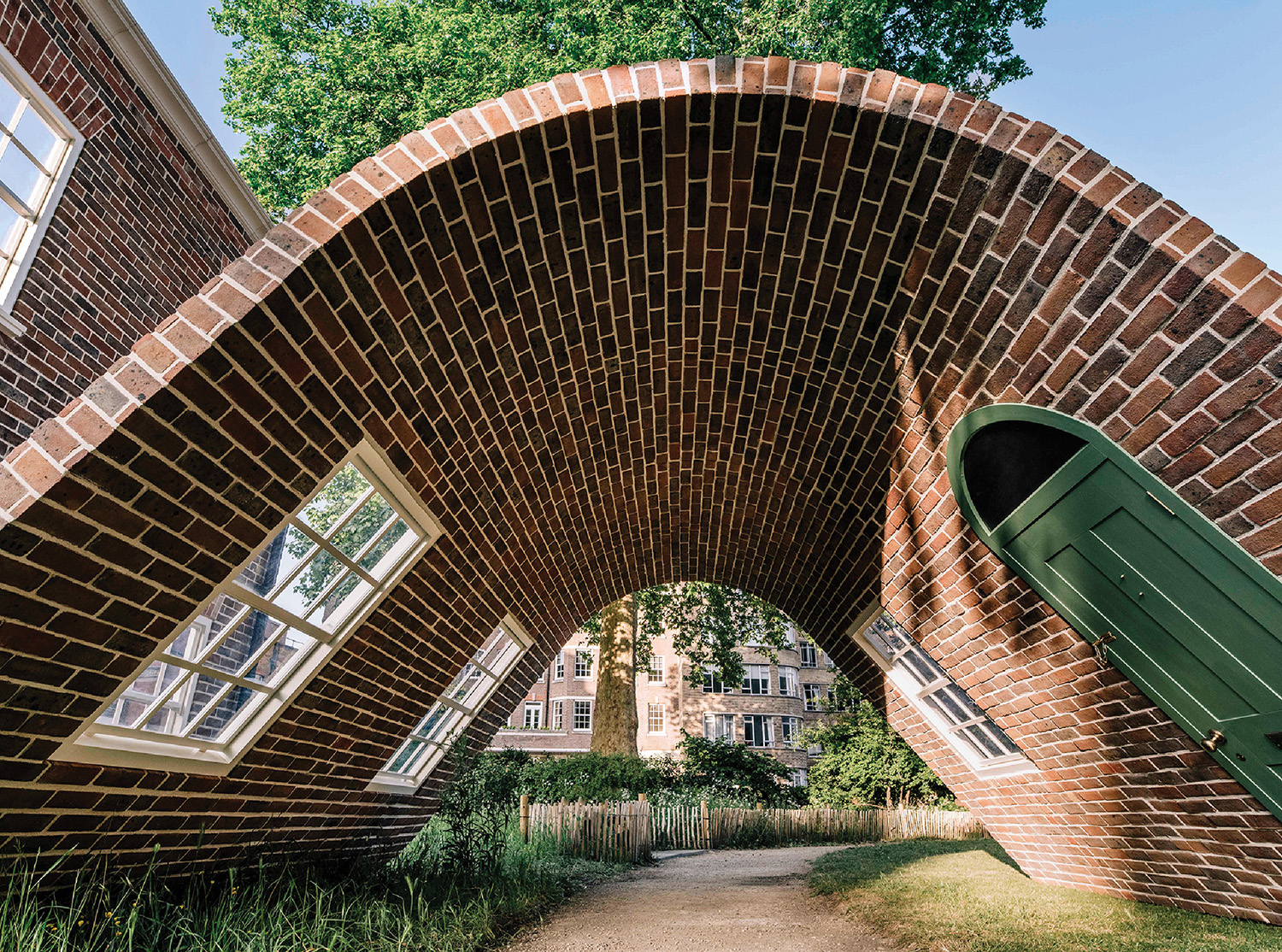 A brick arch with a green door