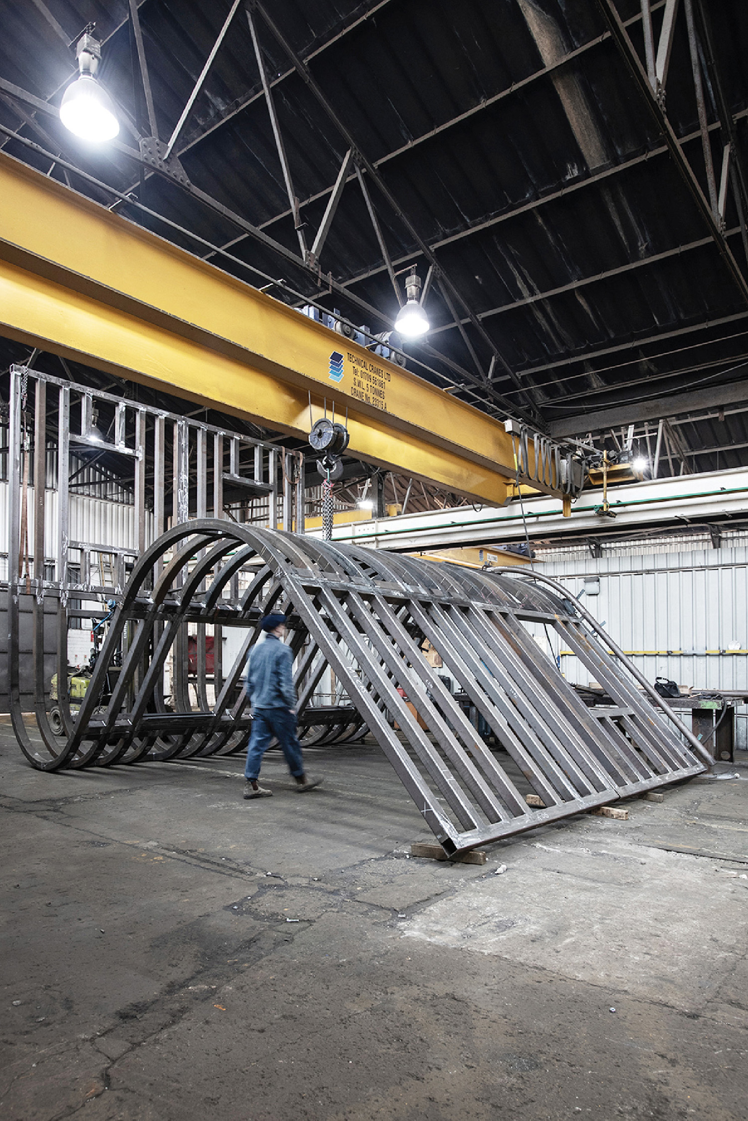 A man is working on a large metal structure