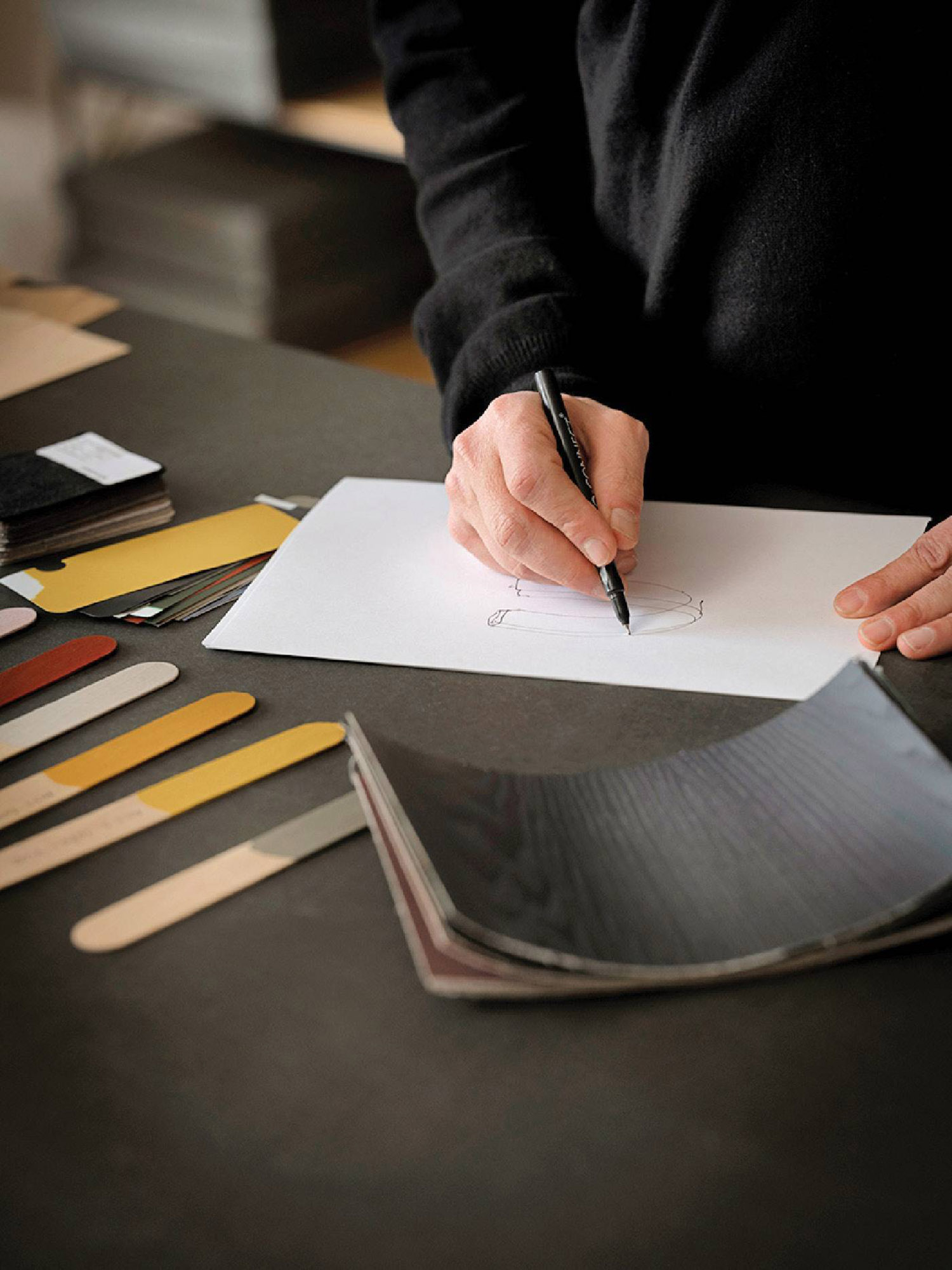 A person writing on a piece of paper.