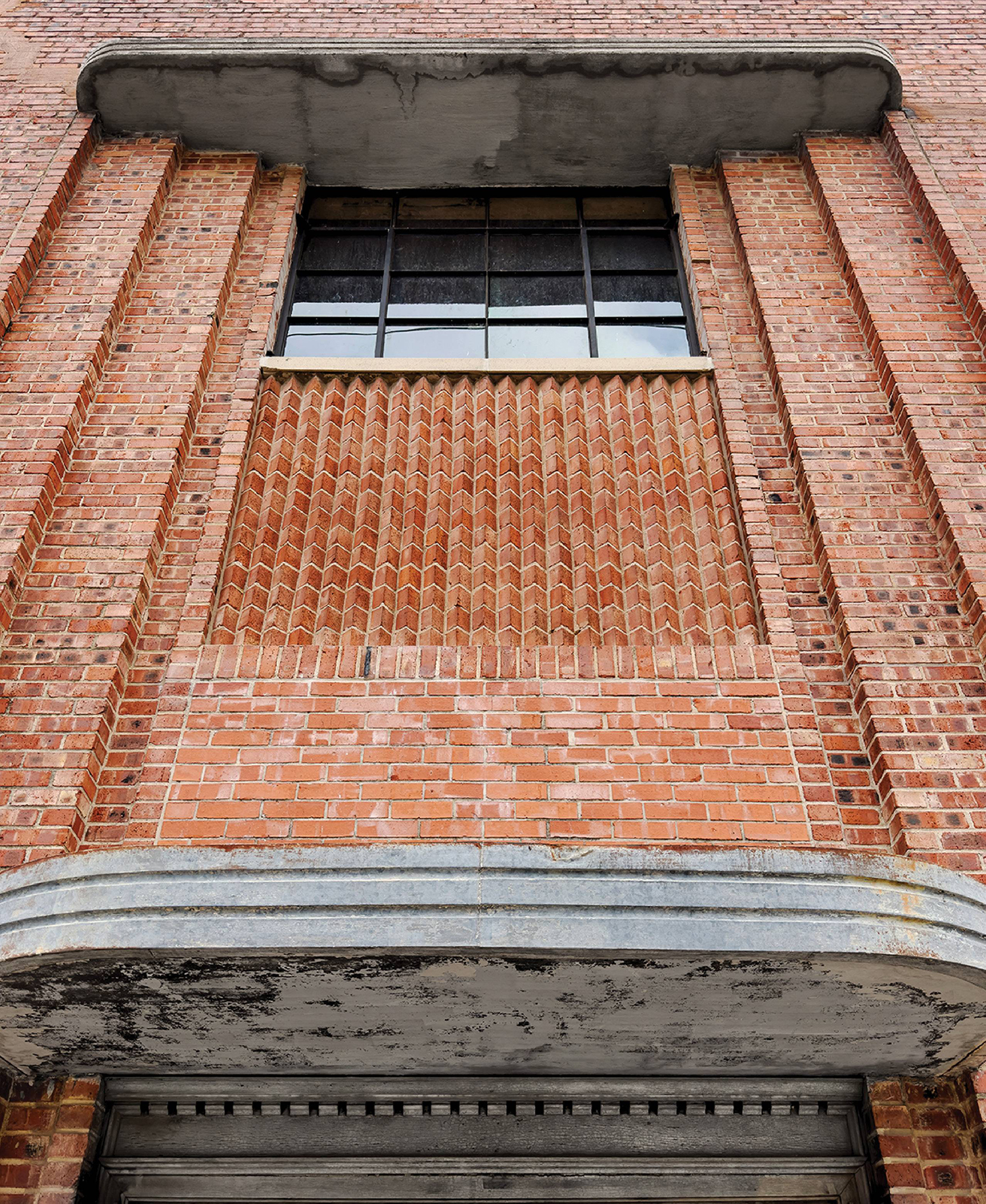 A brick building with a window and a clock