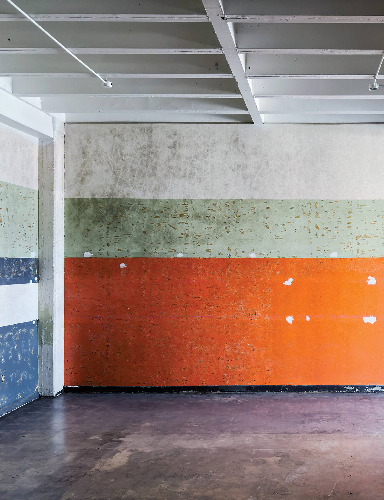 A room with a wall painted in different colors