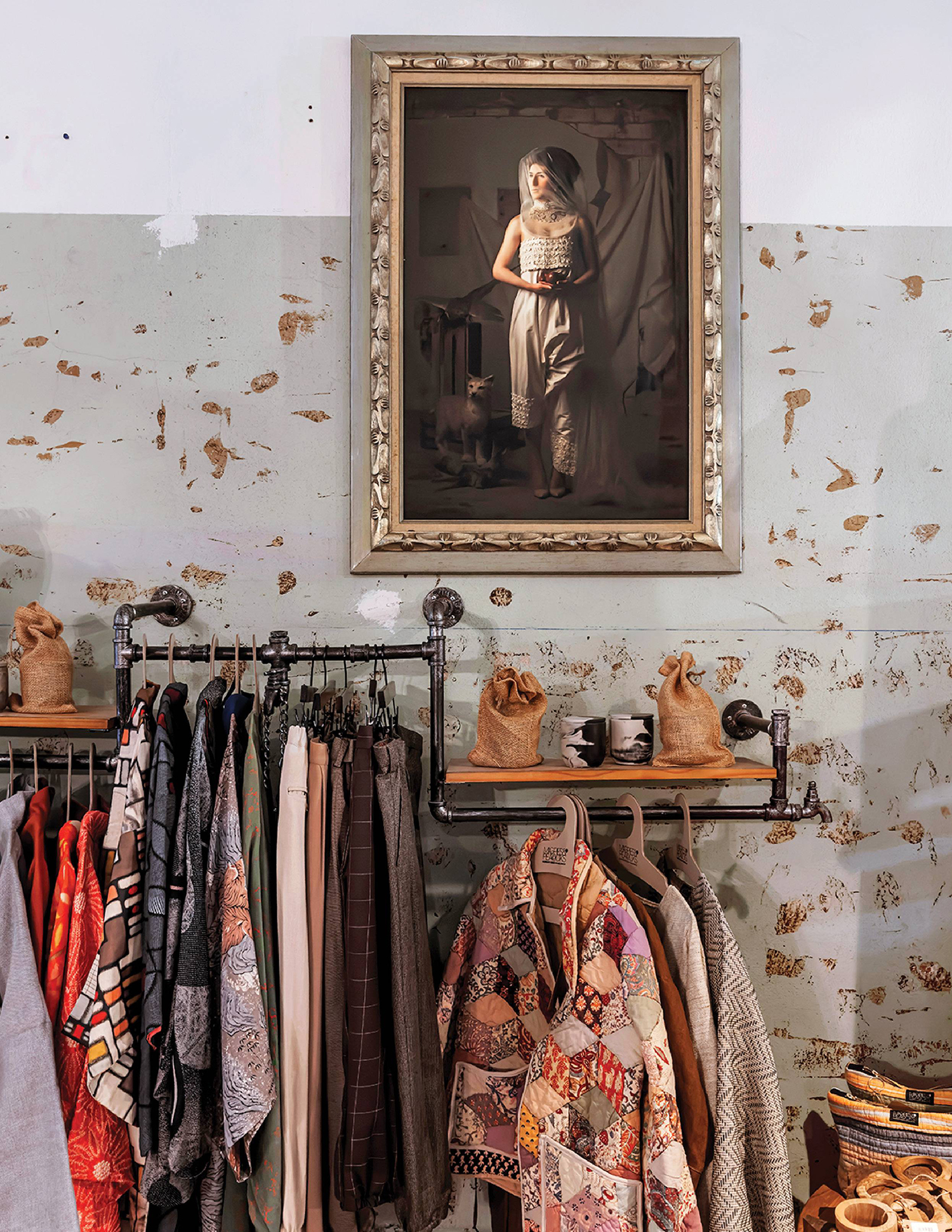 A picture of a woman in a dress hangs on a wall