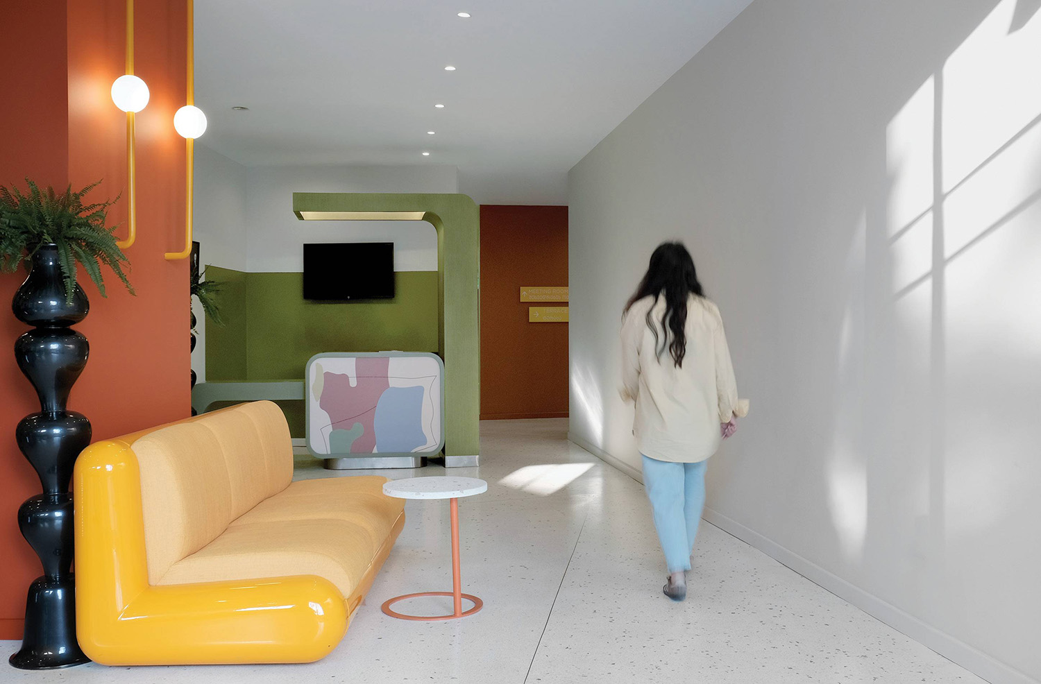 A woman walking down a hallway in a house