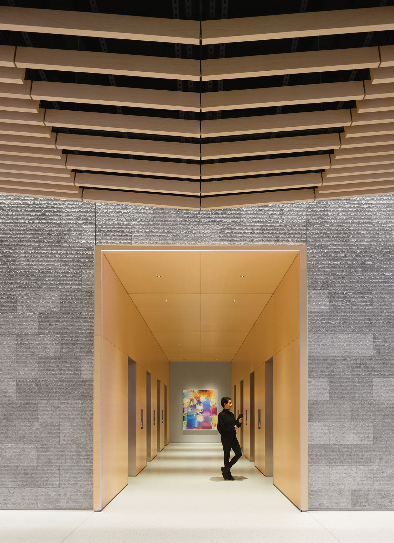 A man is walking through a long hallway