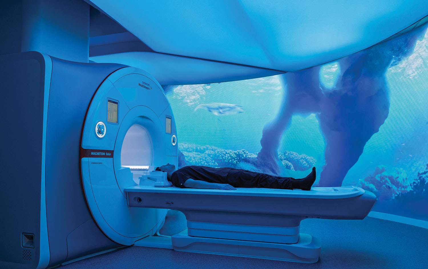 A man laying on a bed in a room