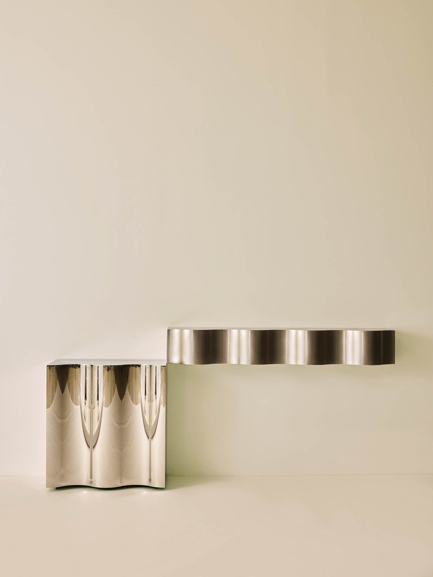 A silver table with two silver vases on top.