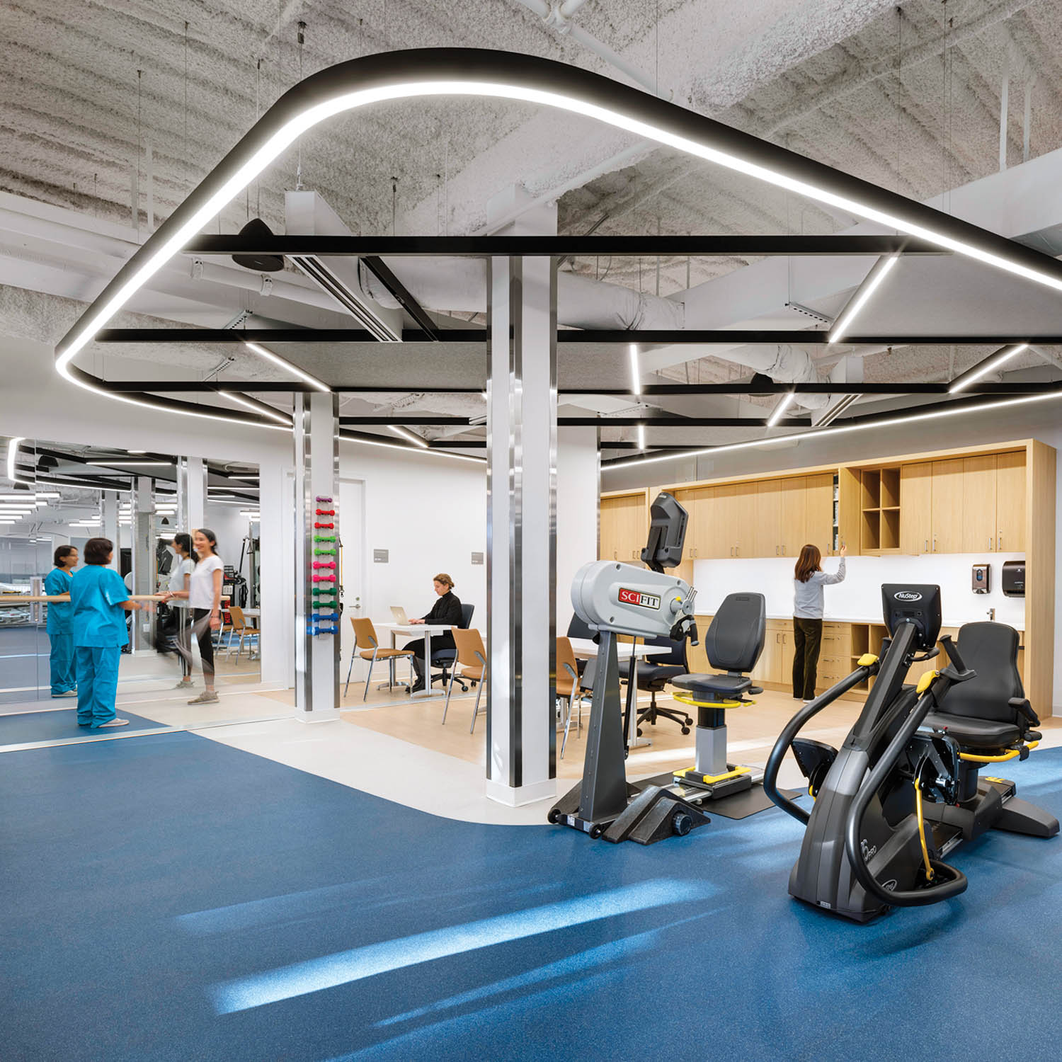 physical therapy clinic with soft lighting and blue carpet