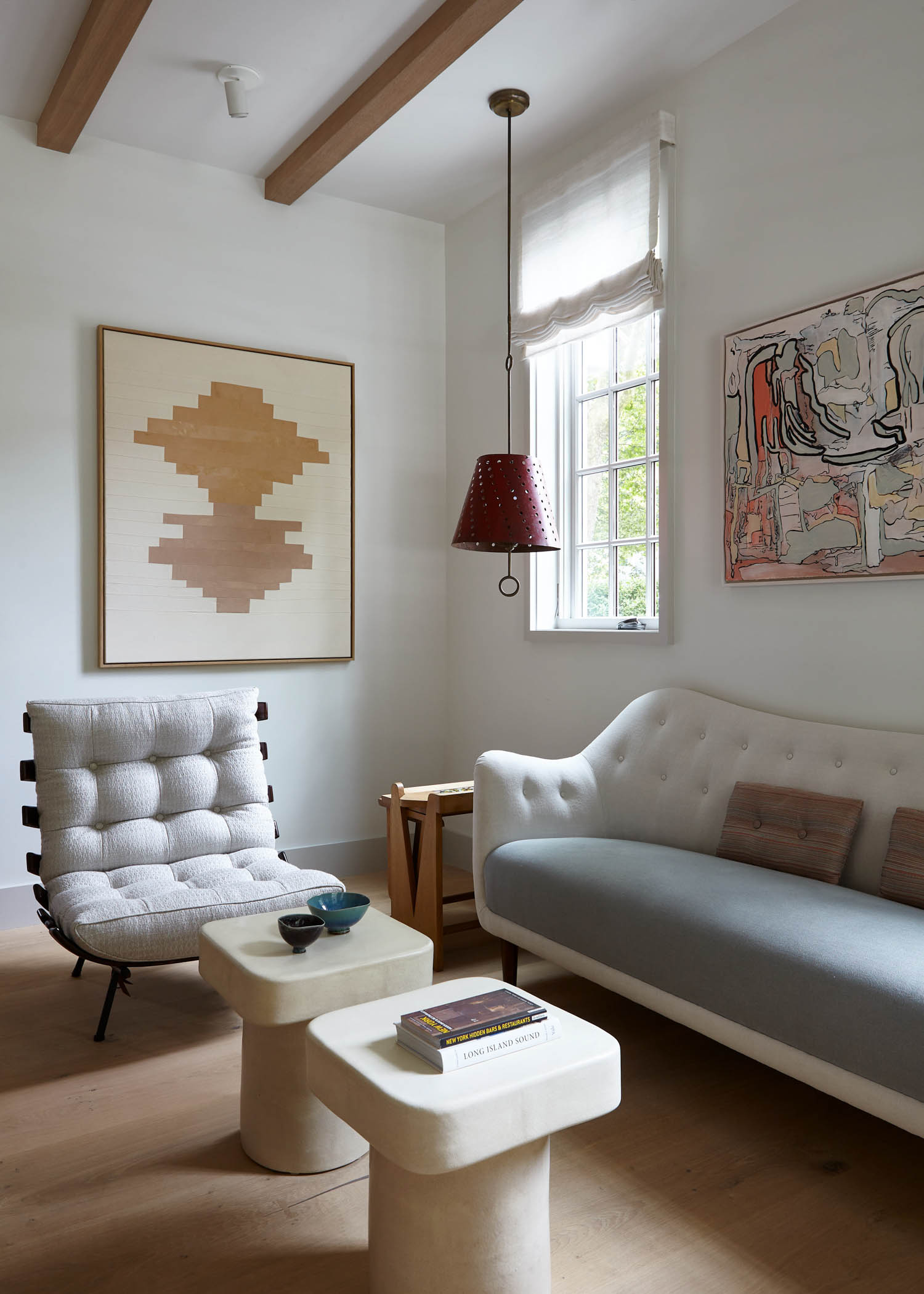 sitting area with white couches and funky art
