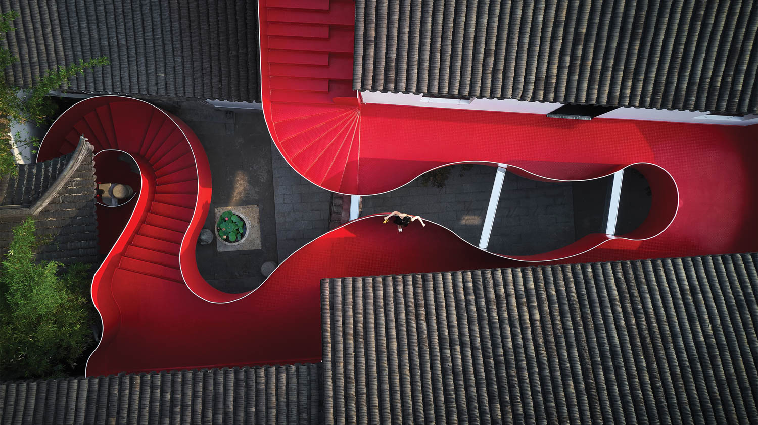 aerial view of roofs over a building with red flooring