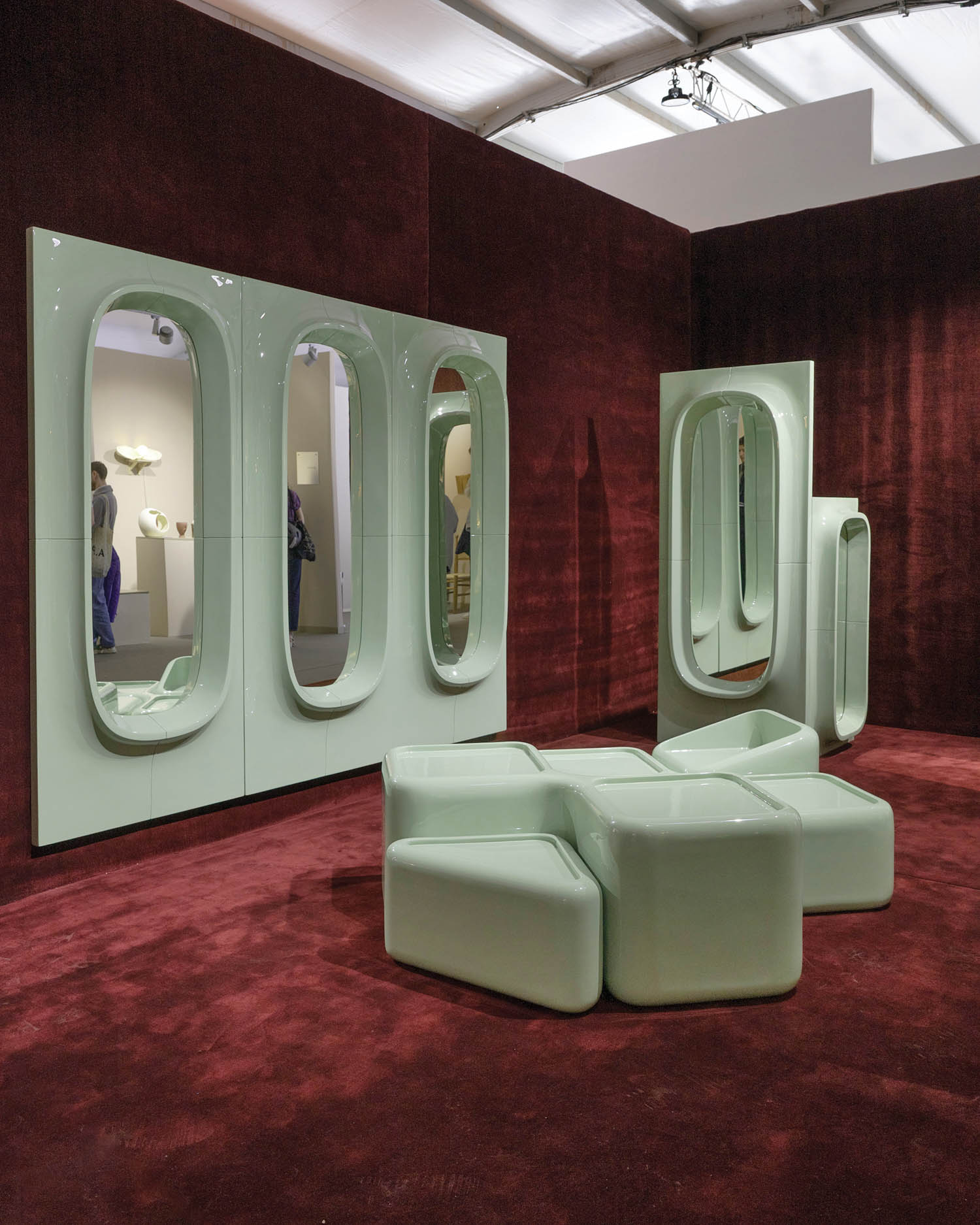 room with pastel green furnishings and red carpet