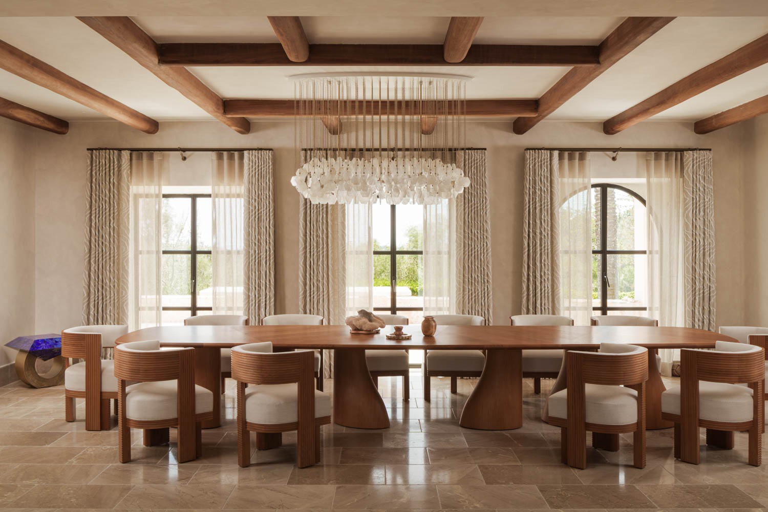 dining room with wooden chairs and sculptural chandelier
