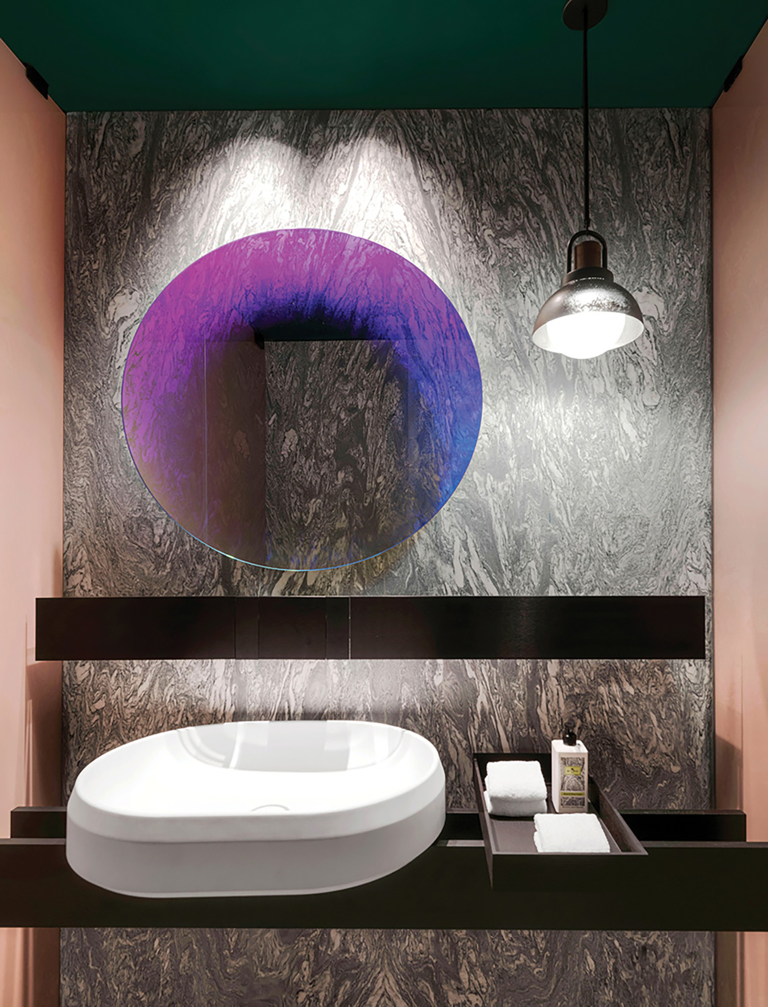A bathroom with a sink and a mirror.
